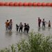 Justice Department sues Texas over floating barrier on the Rio Grande
