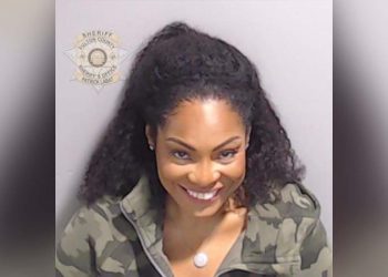 Former Kanye West publicist Trevian Kutti grins in mugshot after being booked in Trump election case