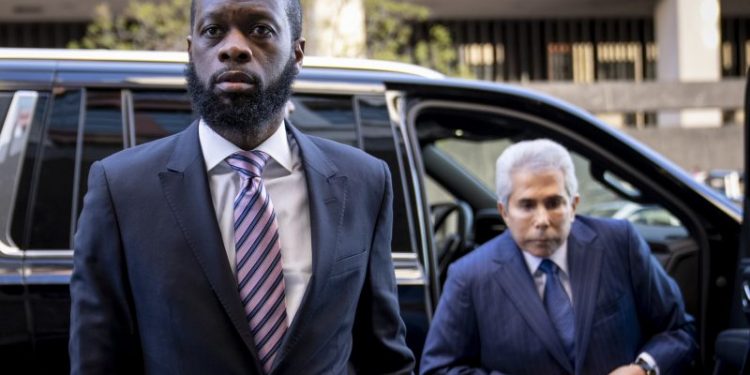 Ex-DOJ employee who testified against Fugees rapper sentenced